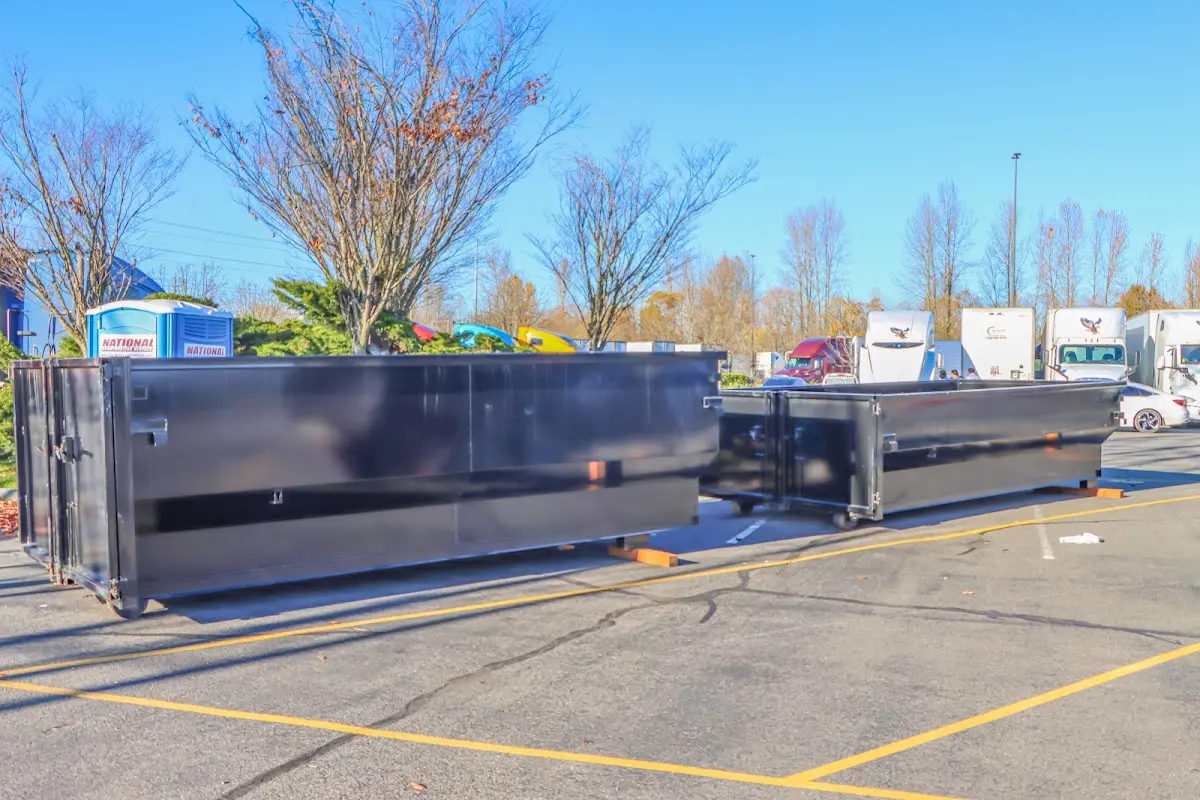 Professional dumpster rental service with roll-off container on residential driveway in Ilion